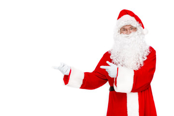 Just look at that! Traditional Santa Claus holding copy space while standing against white background
