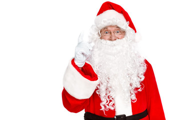 Idea! Traditional Santa Claus pointing up while standing against on white background
