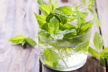 Green fresh mint on the wooden table