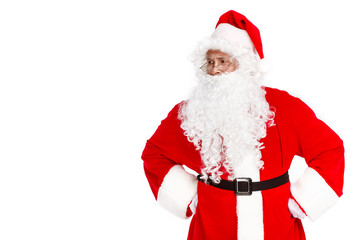 Serious Santa Claus looking away while standing on white background. Copy space.
