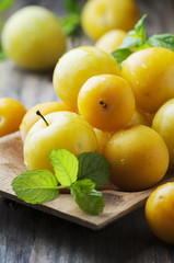 Summer sweet yellow plums on the wooden table