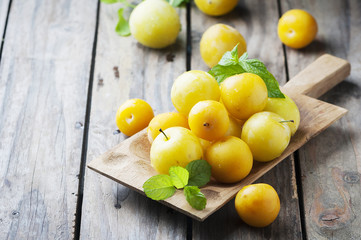 Summer sweet yellow plums on the wooden table