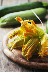 Raw courgette flower on the wooden table