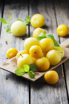 Summer sweet yellow plums on the wooden table