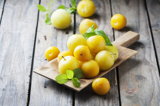 Summer sweet yellow plums on the wooden table