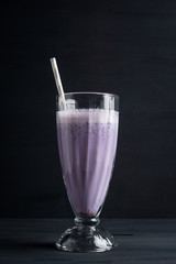 Blueberry milkshake on the wooden background