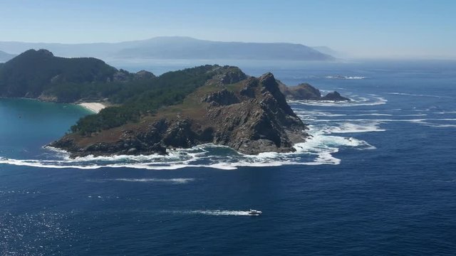 A boat passes by the Cies Islands Natural Park. The Cies Islands are an archipelago off the coast of Vigo in the mouth of the Ria de Vigo.
