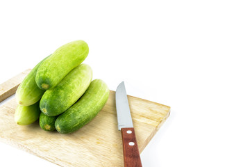 Cucumber on cutting board on white background
