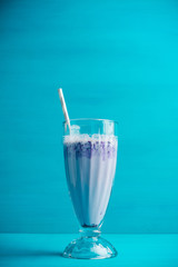 Blueberry milkshake on the wooden background