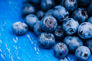 Ripe blueberries on the wooden background