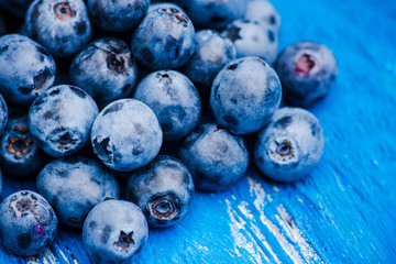 Ripe blueberries on the wooden background