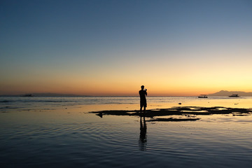 Photographer in a coastal sunset 