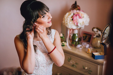 Beautiful young bride in a white dress. Last preparations for the wedding. The bride is waiting for...