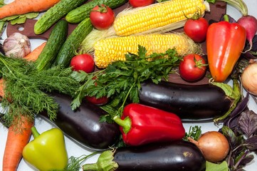 Fresh vegetables and greens on the kitchen table