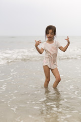 Fototapeta na wymiar Girl in water from a beach