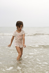 Fototapeta na wymiar Girl in water from a beach