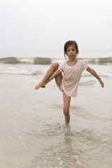 Fototapeta na wymiar Girl in the water of a beach