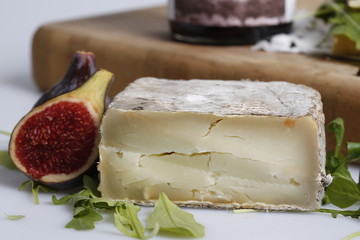 Cheese with fig close up on a served food place