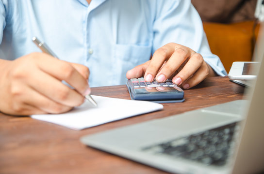 Businessman Using A Calculator To Calculate The Numbers. Account