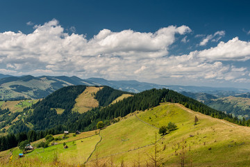 Obraz premium Beautiful mountain landscape. Blue sky, green meadows.