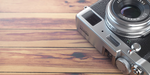 Retro vintage camera on wood table background. Space for text.