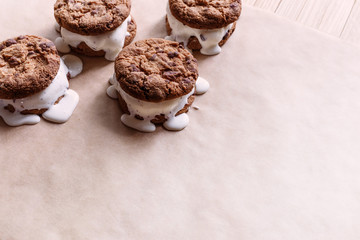 Melting ice-cream sandwiches on a wooden background
