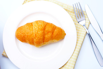 Top view of croissants on a white plate.