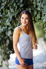 Young woman walking on green forest