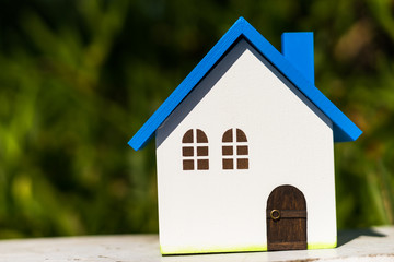 Obraz na płótnie Canvas Home image, blue house toy under blue sky