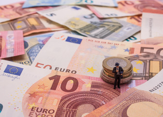 Mann im Anzug mit Münzen vom Euro