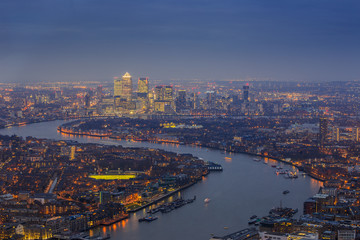 London, England - Panoramic skyline view of east London with the skyscrapers of Canary Wharf at blue hour