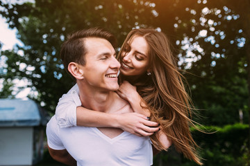 Fototapeta premium Young adult brunette man and woman in the park