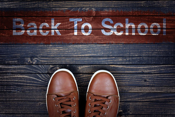 Back to School message and sport shoes on floor