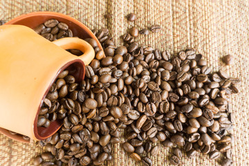 black coffee in brown cup pottery and roasted coffee beans on ta