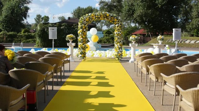 Arch and chairs prepared for an outdoor ceremony