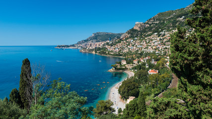 Fototapeta na wymiar Bay and coastline of Roquebrune-Cap-Martin, Southern France with the city state of Monaco in the distance.