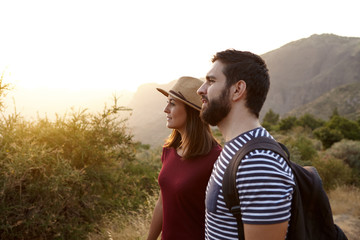 Sweet young couple surrounded by mountains