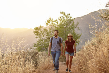Young couple strolling in the mountains