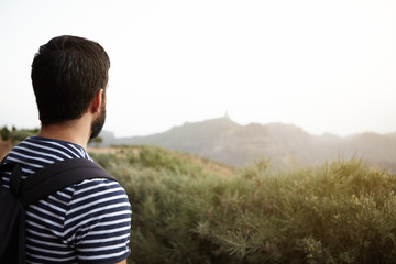 Young man looking out over mountains