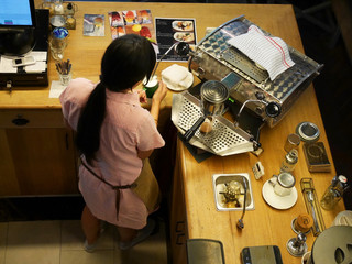 Barista making milk creme foam with coffee maker machine