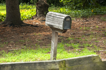American outdoor wooden mailbox on wooden support