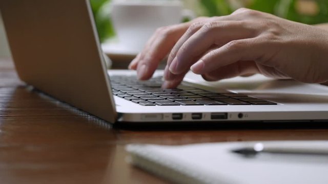 Woman hands typing on the keyboard of laptop computer. Hight quality shot, UHD, 4K
