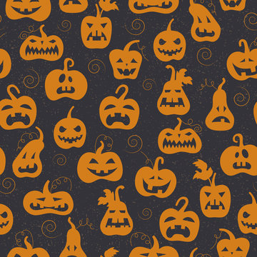 Seamless pattern on the theme of Halloween, different shapes orange pumpkins on a dark background