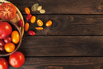 Fototapeta na wymiar Tomatoes on wooden table background, top view