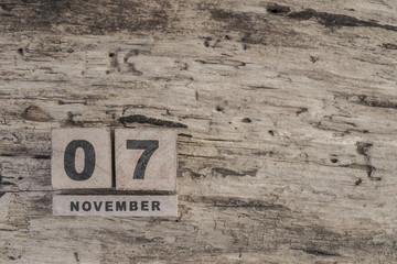 cube calendar for november on wooden surface with copy space