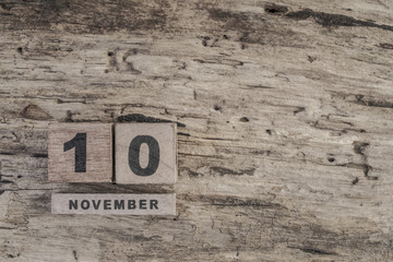 cube calendar for november on wooden surface with copy space