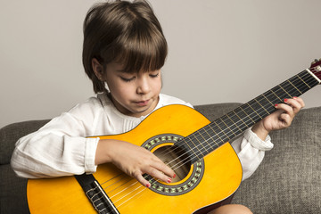 Little girl playing guitar