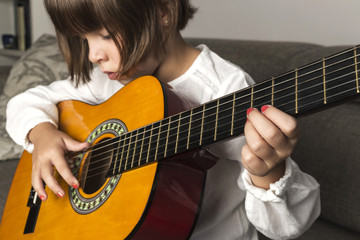 Little girl playing guitar