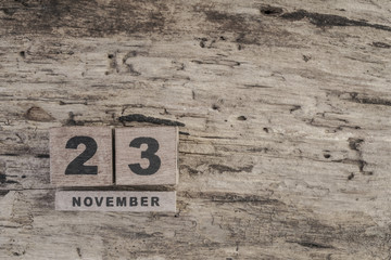 cube calendar for november on wooden surface with copy space