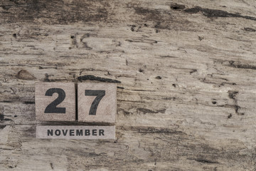 cube calendar for november on wooden surface with copy space